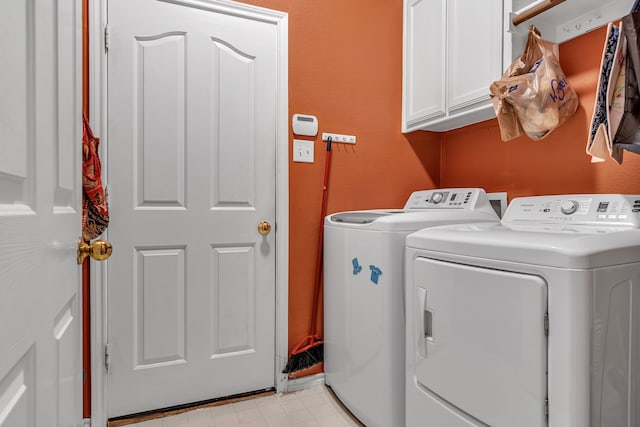 washroom featuring cabinet space, independent washer and dryer, and light floors