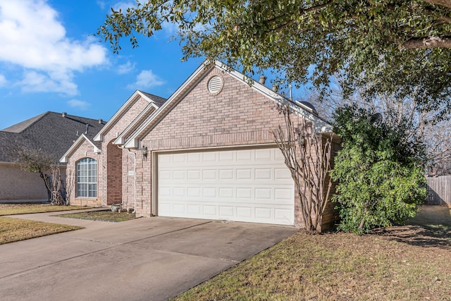 ranch-style home featuring concrete driveway, brick siding, and an attached garage