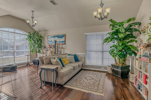 living room with lofted ceiling, visible vents, a chandelier, and wood finished floors