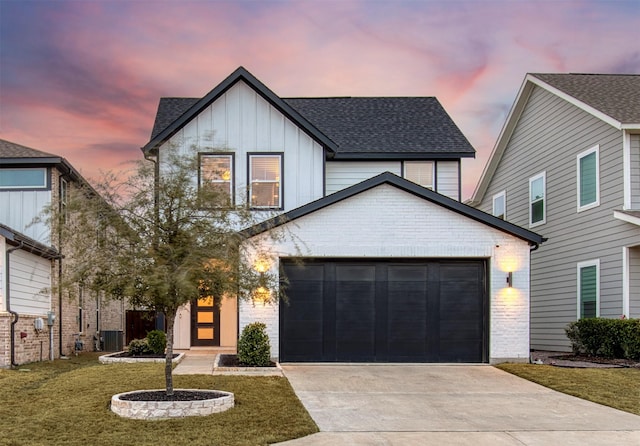 view of front of property featuring a garage, brick siding, board and batten siding, and a shingled roof