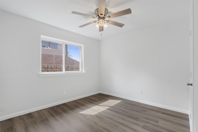 spare room featuring ceiling fan, wood finished floors, and baseboards