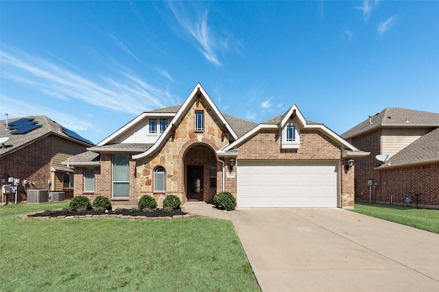 view of front of home featuring brick siding, central air condition unit, concrete driveway, an attached garage, and a front lawn