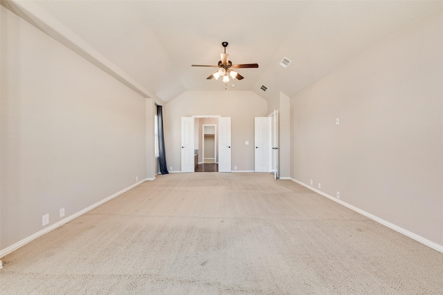 unfurnished room with carpet floors, lofted ceiling, visible vents, ceiling fan, and baseboards