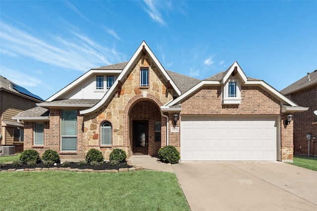 tudor house with brick siding, roof with shingles, concrete driveway, a garage, and stone siding