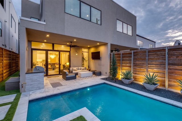 rear view of house featuring a fenced in pool, outdoor lounge area, a patio, and fence