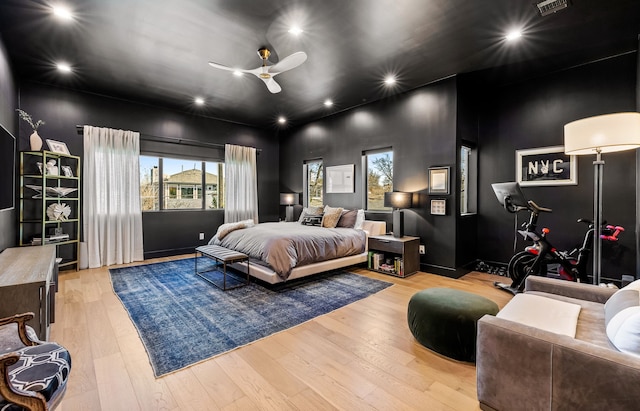 bedroom with a ceiling fan, wood finished floors, visible vents, and recessed lighting