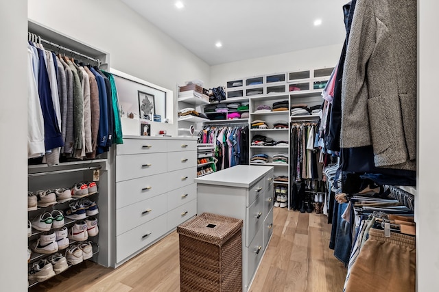 walk in closet with light wood-style floors