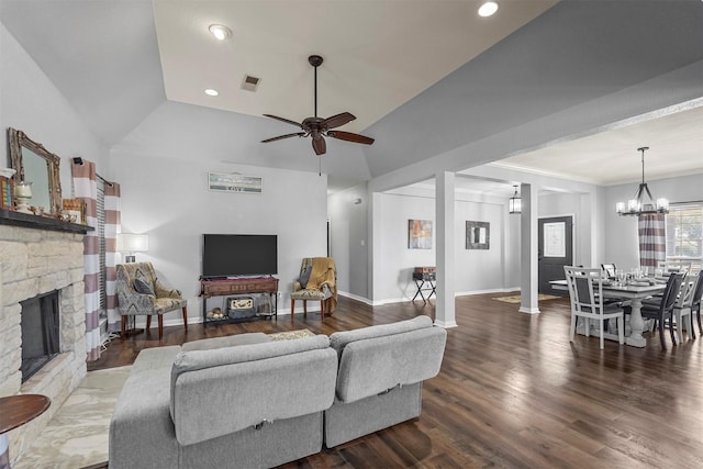 living area featuring a fireplace, visible vents, wood finished floors, baseboards, and ceiling fan with notable chandelier