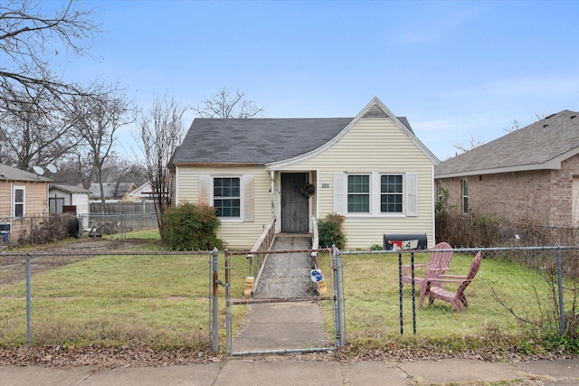 bungalow featuring a front lawn, a fenced front yard, and a gate