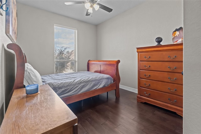 bedroom featuring dark wood-type flooring, ceiling fan, and baseboards