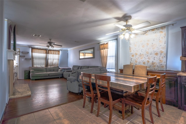 dining area with ceiling fan, tile patterned floors, visible vents, and crown molding