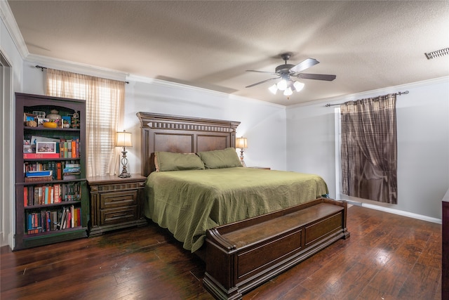 bedroom with ornamental molding, visible vents, a textured ceiling, and hardwood / wood-style floors