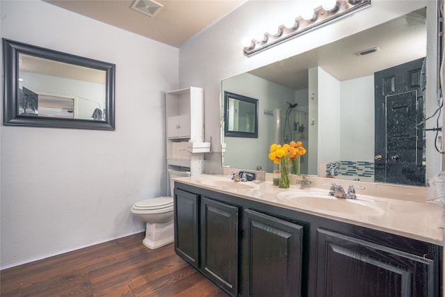 full bathroom with wood finished floors, a sink, and visible vents