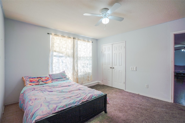 carpeted bedroom featuring a textured ceiling, a closet, a ceiling fan, and baseboards