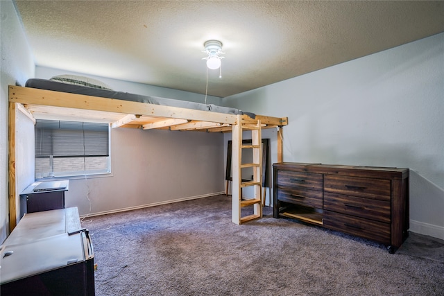 bedroom with carpet floors, a textured ceiling, and baseboards