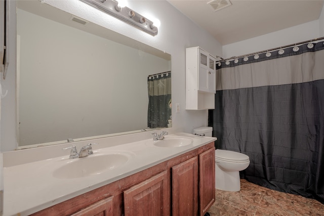 full bathroom featuring toilet, a sink, and visible vents