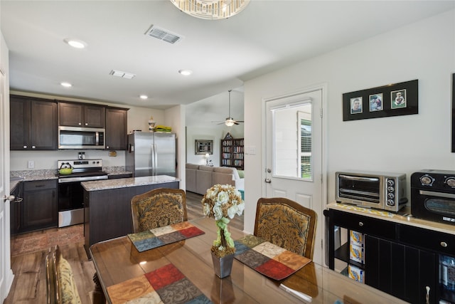 dining area with a toaster, visible vents, dark wood finished floors, and recessed lighting