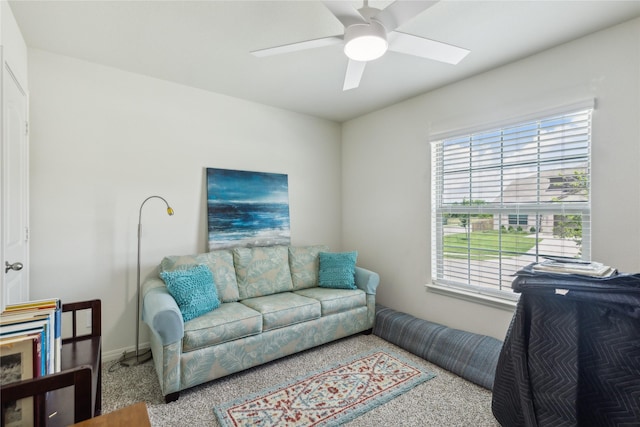 living area with carpet floors and ceiling fan