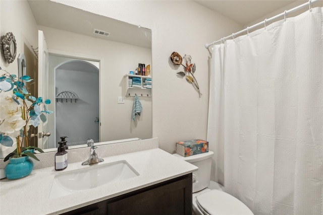 full bath with toilet, visible vents, and vanity