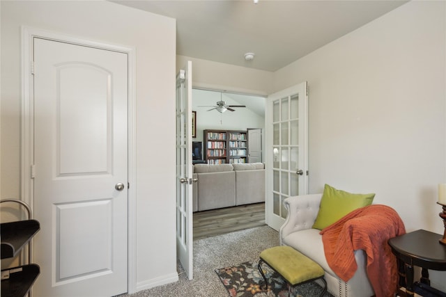 sitting room with carpet, ceiling fan, and french doors