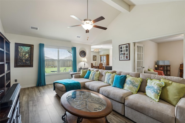 living room featuring ceiling fan, beamed ceiling, wood finished floors, and visible vents