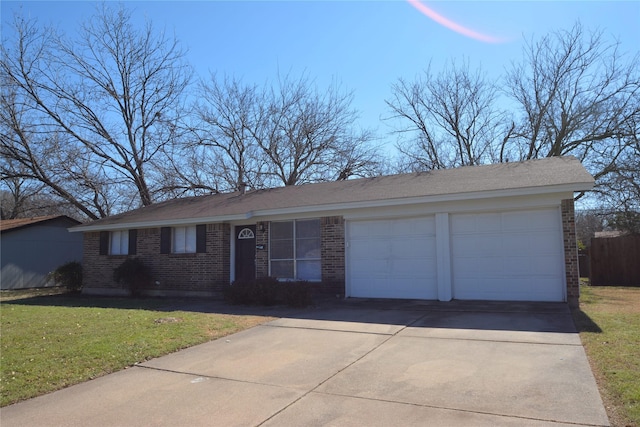 ranch-style home featuring a garage, a front yard, concrete driveway, and brick siding