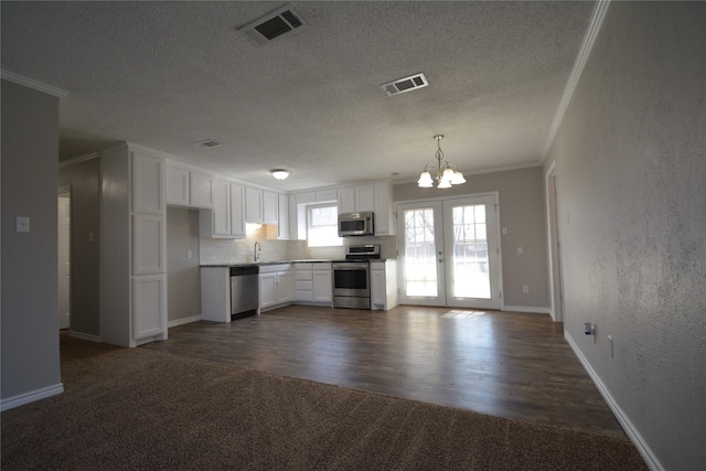 kitchen featuring crown molding, appliances with stainless steel finishes, visible vents, and white cabinets