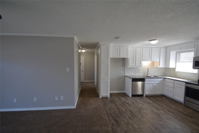 kitchen featuring white cabinets, visible vents, stainless steel appliances, and a sink