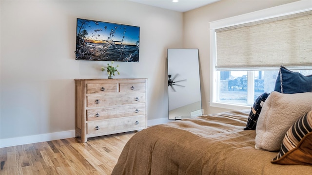 bedroom with baseboards and wood finished floors