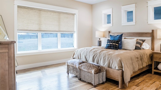 bedroom featuring wood finished floors and baseboards