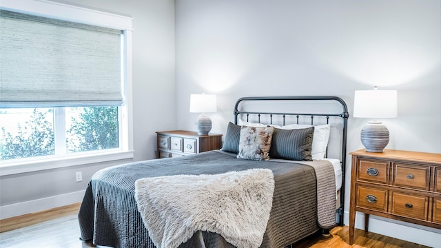 bedroom featuring baseboards and wood finished floors