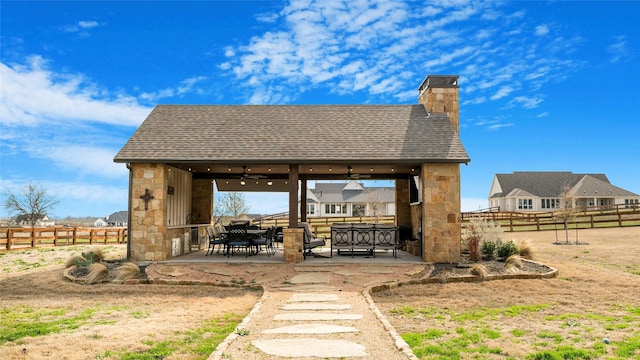 view of property's community featuring a patio area, fence, and a gazebo