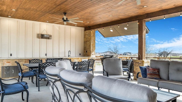 view of patio / terrace with outdoor dining area, ceiling fan, a sink, and an outdoor hangout area