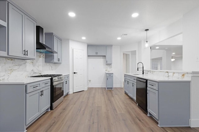 kitchen featuring stainless steel gas stove, dishwasher, wall chimney range hood, and gray cabinetry