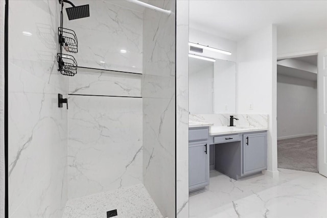 full bathroom featuring marble finish floor, a marble finish shower, and vanity