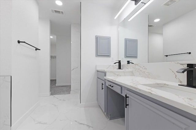 full bathroom with marble finish floor, double vanity, a sink, and visible vents