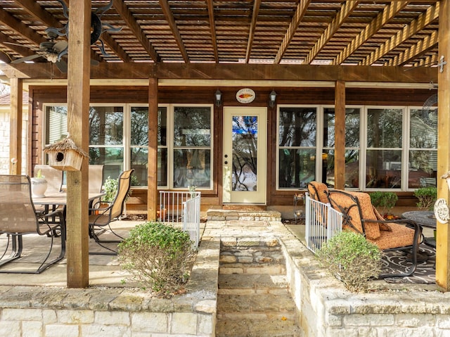 property entrance featuring a patio area, outdoor dining area, and a pergola