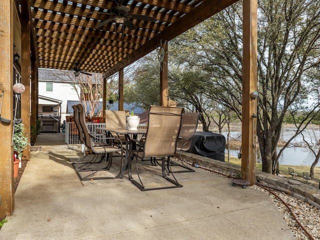 view of patio / terrace with outdoor dining space, a water view, a ceiling fan, and a pergola