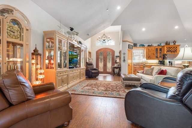 living room featuring arched walkways, high vaulted ceiling, a chandelier, hardwood / wood-style flooring, and french doors