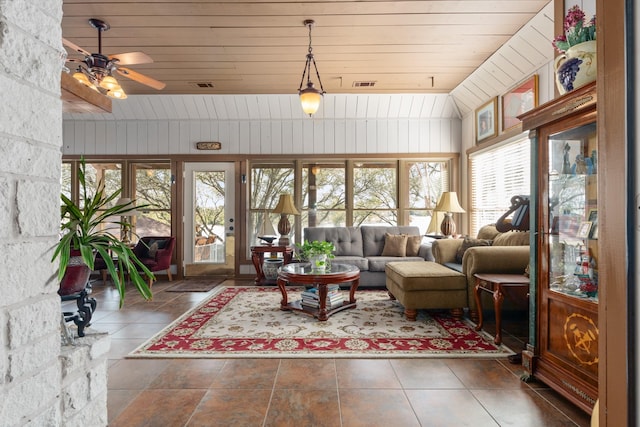 sunroom / solarium with lofted ceiling, wood ceiling, visible vents, and a ceiling fan