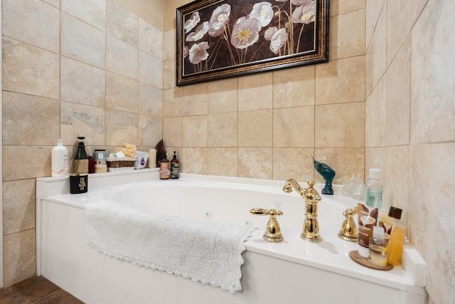 full bath featuring a jetted tub and tile walls