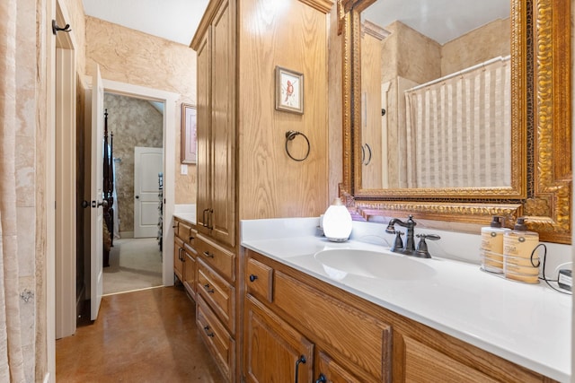 full bath featuring curtained shower, vanity, and finished concrete floors