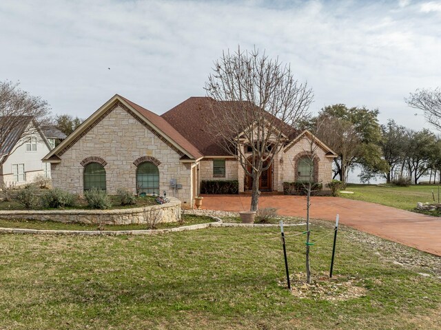 french country style house featuring a front lawn