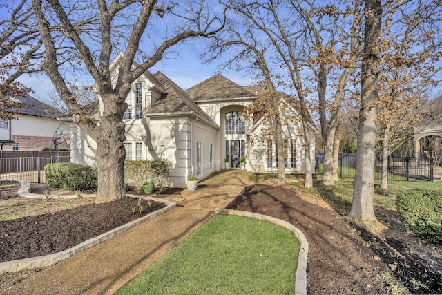 view of front of property featuring fence and stucco siding