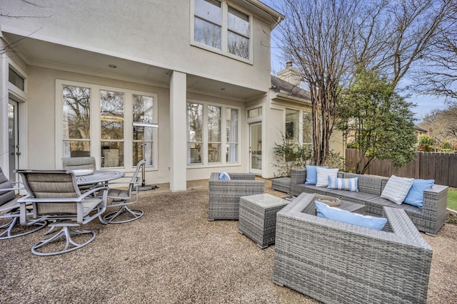 view of patio featuring fence and an outdoor living space