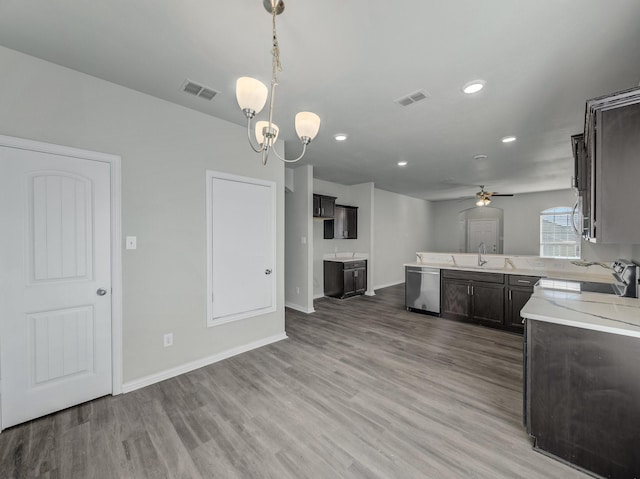 kitchen with dishwasher, range, a sink, and visible vents