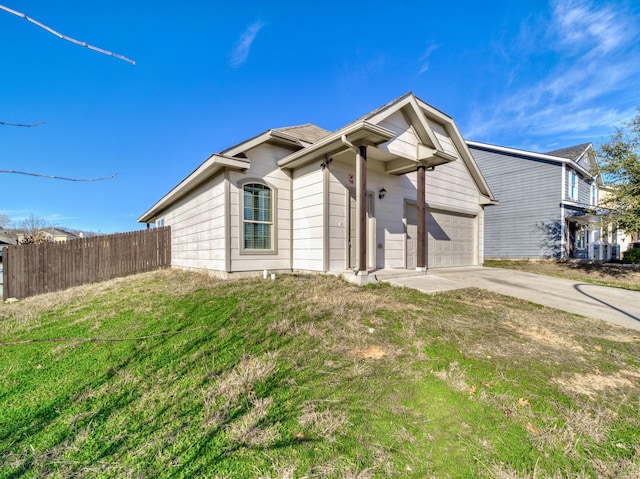 exterior space with concrete driveway, fence, and an attached garage