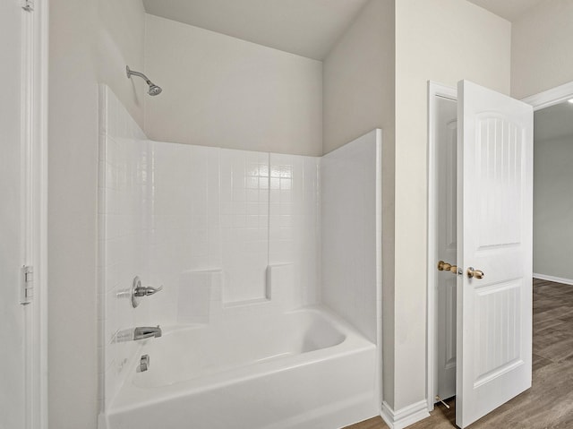 full bath with bathtub / shower combination, baseboards, and wood finished floors