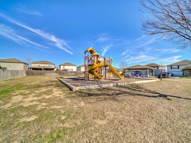 communal playground with a yard and fence