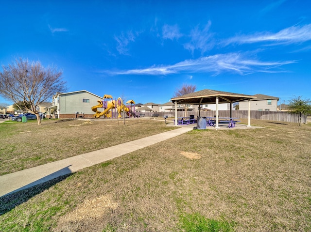 view of yard with fence, playground community, and a gazebo